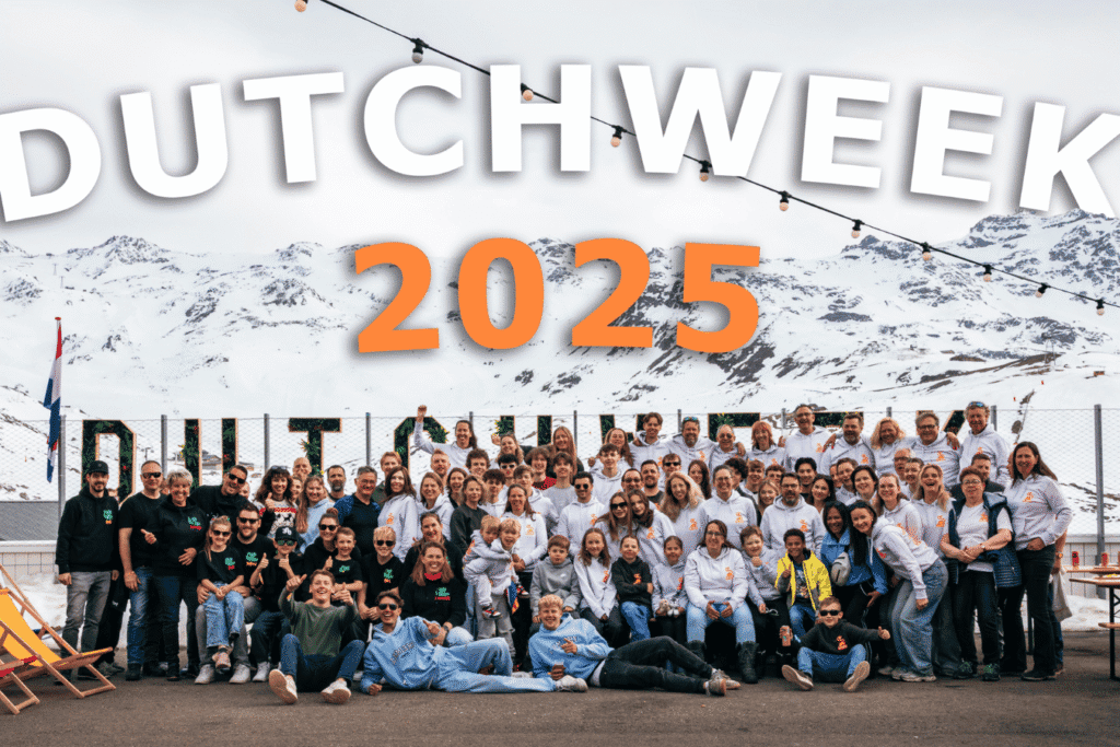 Ski- en snowboardliefhebbers op een groepsevent tijdens Dutch Week 2025 in Almere, met sneeuwrijke bergen op de achtergrond en een vrolijke sfeer met veel deelnemers.